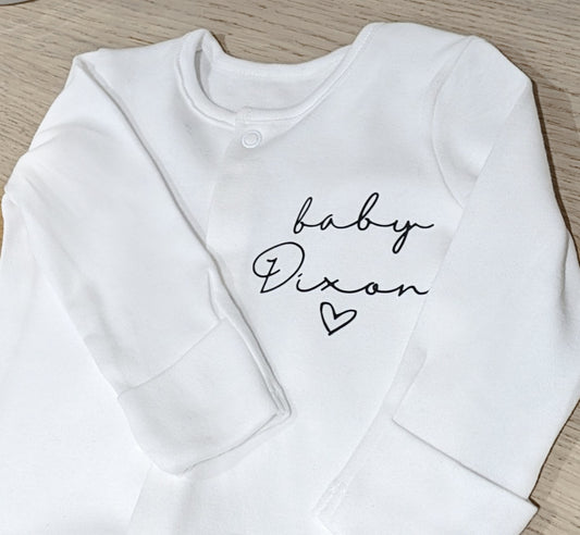 Sleepsuit with "baby", surname and love heart.