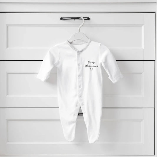 Sleepsuit with baby and surname.