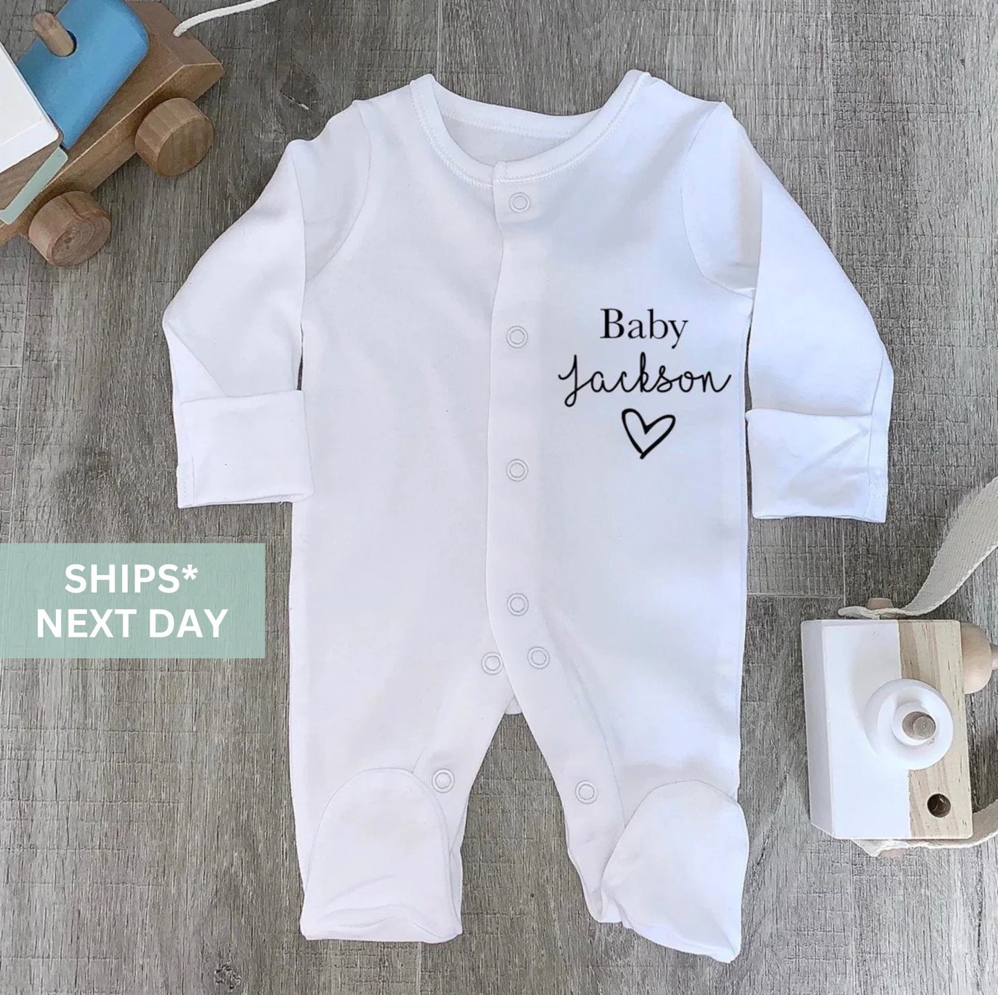 Sleepsuit with surname and love heart.