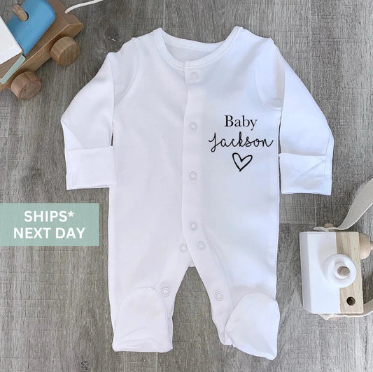 Sleepsuit with surname and love heart.