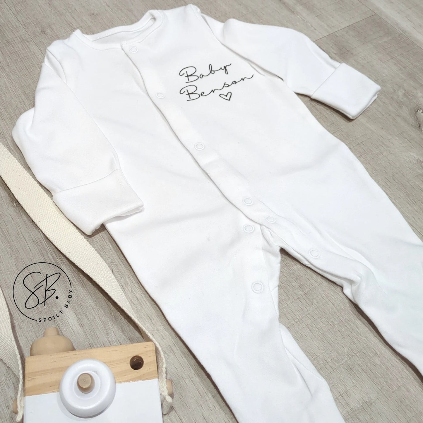 Sleepsuit with "baby", surname and love heart.